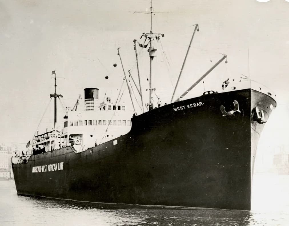 The West Kebar, a black-hulled freighter, with her name on the bow and American-West African Line painted along her side
